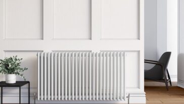 White Elegant Showers traditional 3 column radiator under a window in a panelled living room