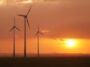 Wind turbines silhouetted against an orange sunset sky, from the Ecotricity website