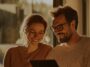 Couple relaxing on a sofa at home looking at a tablet together, from Superloop residential internet